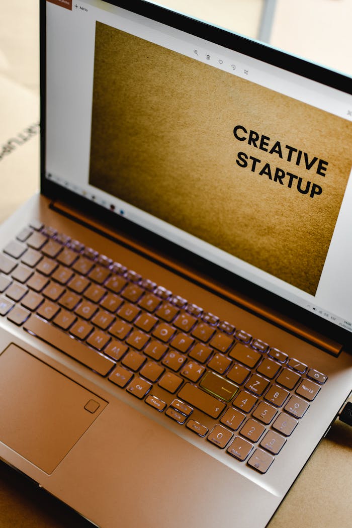 Laptop displaying 'Creative Startup' concept in an inspiring workspace.